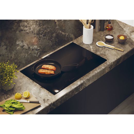 Haier HAMTB86IRCS Induction Hob - Black - Pan cooking on hob in kitchen shot