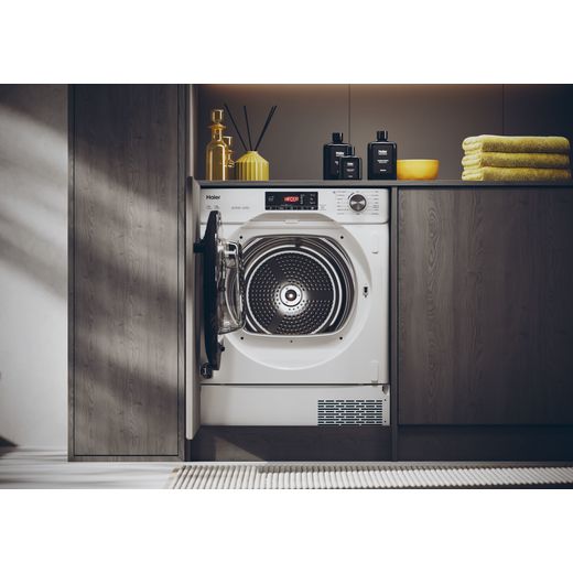 Haier 31900541 Integrated Heat Pump Tumble Dryer - White - Tumble dryer in laundry room with door open