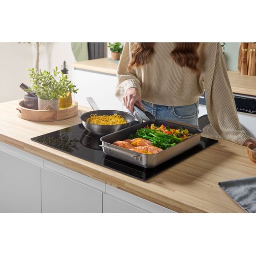Bosch Series 4 PWP611BB5B 59cm Induction Hob - Black - food cooking on hob shot