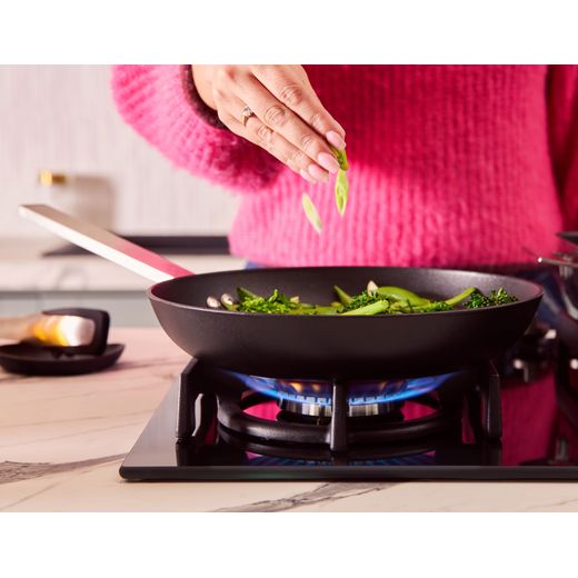 NEFF N70 T26PIP4S0 59cm Gas Hob - Black -  women making stir fry shot