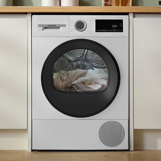 Bosch Series 6 WQG24502GB 9Kg Heat Pump Tumble Dryer - White - machine in kitchen shot