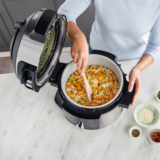 Ninja Foodi Max 15-in-1 SmartLid 7.5 Litre Multi Cooker - Stainless Steel / BlackNinja Foodi Max 15-in-1 SmartLid 7.5 Litre Multi Cooker - Stainless Steel / Black - Women in modern kitchen preparing a meal