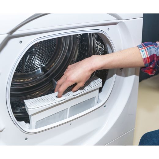 Candy 10Kg Condenser Tumble Dryer - White - Person lifting the filter on the inside of the machine