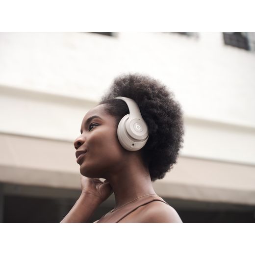 Beats Headphones - Sandstone - Women wearing headphones outside shot