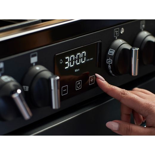 Belling Farmhouse 100E 100cm Electric Range Cooker with Ceramic Hob - Black - Person using control panel shot 