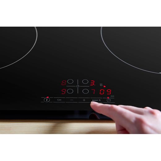 Bosch Series 4 PIE631BB5E 59cm Induction Hob - Black - person using control panel shot
