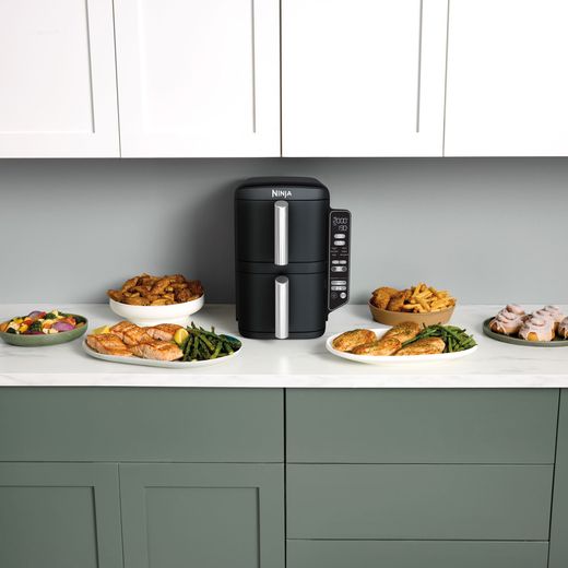 Ninja Double Stack XL SL300UK - Grey - Air fryer on kitchen worktop surrounded by cooked food