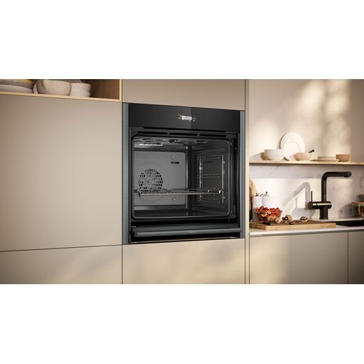 NEFF N70 Slide & Hide® Built In Electric Single Oven - Graphite - Oven in kitchen door open shot