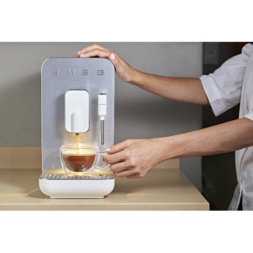Smeg BCC12WHMUK Coffee Machines Matte White - Person using coffee machine shot