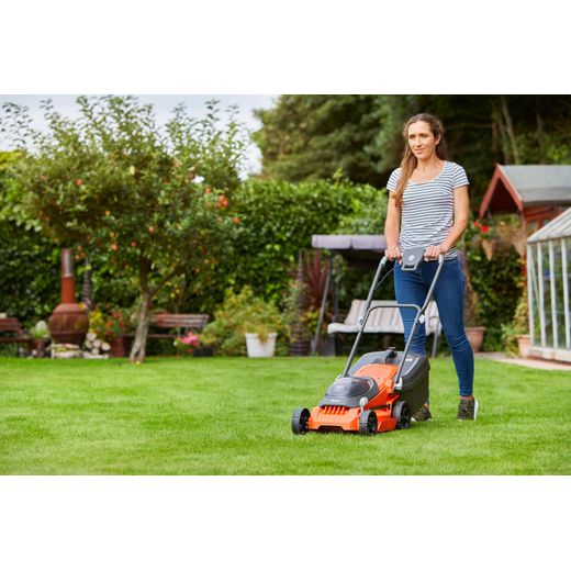 Flymo 36V EasiStore 340R Cordless Lawn Mower - Orange - person cutting grass shot