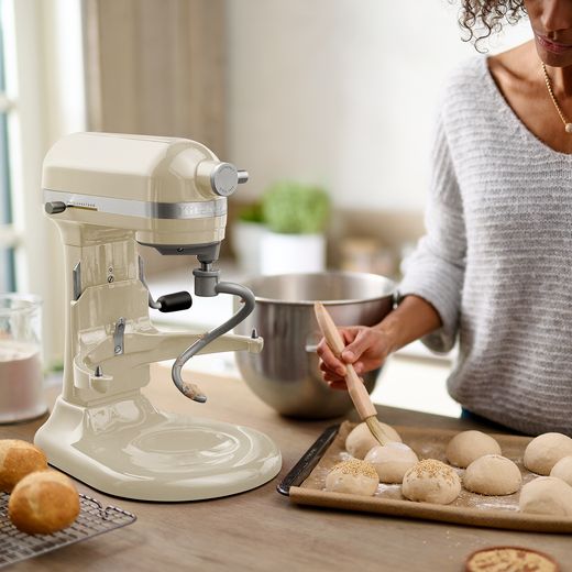 KitchenAid Artisan 5KSM60SPXBAC Stand Mixer with 5.6 Litre Bowl - Almond Cream - Woman preparing baking in the kitchen