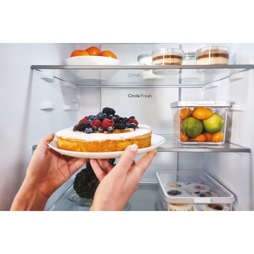 Hoover H-COMBI 300 60/40 Total No Frost Fridge Freezer - Stainless Steel Effect - Women putting cake in fridge shot