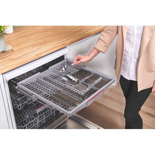Bosch Series 6 Standard Dishwasher - White - Woman filling cutlery drawer