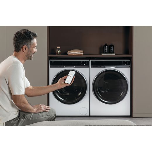 Haier HW110-BD14397U1 11kg Washing Machine with 1400 rpm - White - Man using phone to control machine shot
