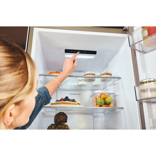 Hoover H-COMBI 300 60/40 Total No Frost Fridge Freezer - Stainless Steel Effect - Women changing control panel shot 