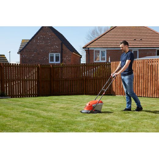 Flymo HoverVac 250 Corded Lawn Mower - Orange - person cutting grass shot