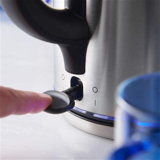 Russell Hobbs Quiet Boil 20460 Kettle - Stainless Steel - Person turning on kettle shot
