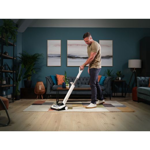 Gtech AirRam Platinum 1-03-273 Cordless Vacuum Cleaner with up to 60 Minutes Run Time - Silver - Man hoovering living room shot