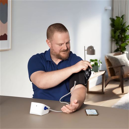 Omron HEM-7146T2-EBK Upper arm Blood Pressure Monitor - Man using blood pressure machine shot
