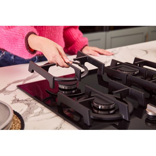 NEFF N70 T26PIP4S0 59cm Gas Hob - Black - person moving pan support shot