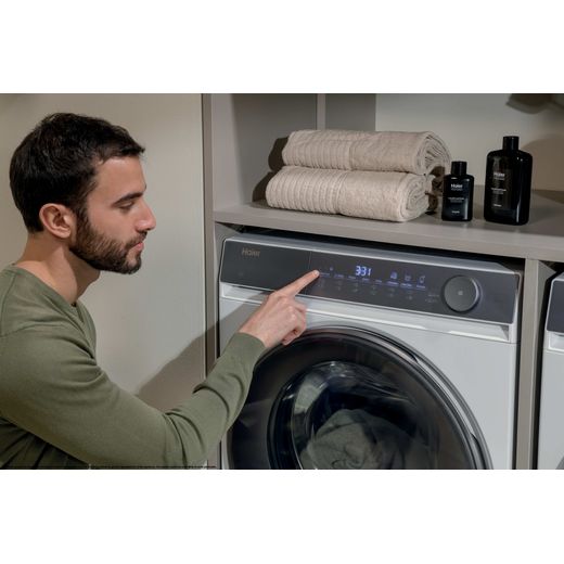 Haier X7 HW100-B14367U-UK 10kg Washing Machine with 1400 rpm - White - man using washing machine 