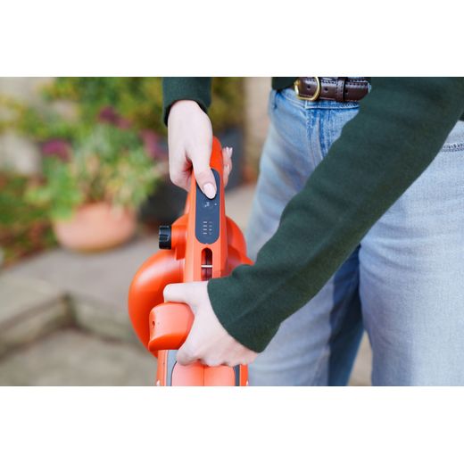 Flymo 9707657-01 Leaf Blower and Vacuum Orange - person changing setting shot