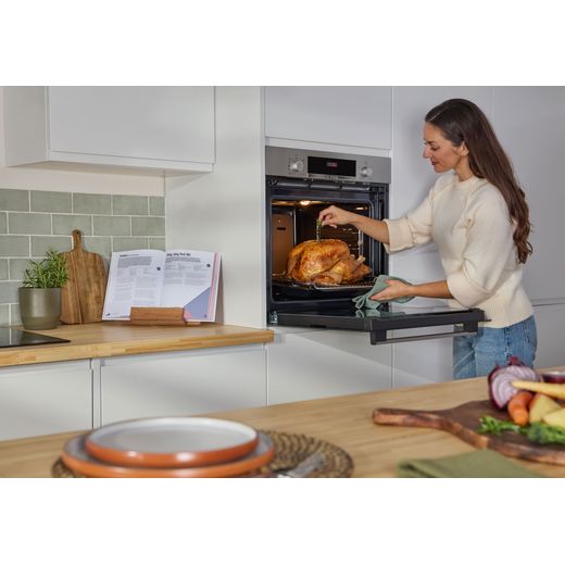 Bosch Series 4 HQA534BS3B Built In Electric Single Oven - Stainless Steel - women cooking chicken in oven