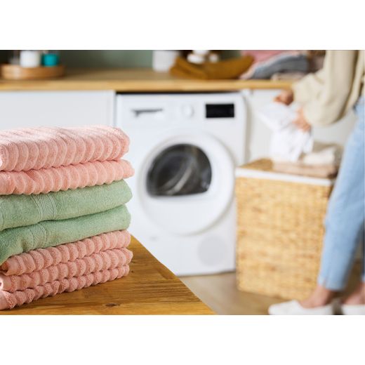 Bosch Series 4 WTH85225GB 8Kg Heat Pump Tumble Dryer - White - Clothes folded on table shot