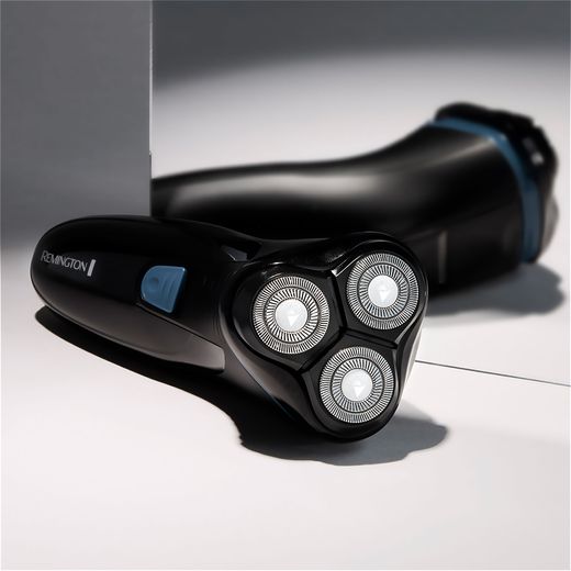 Remington R1 Style Series R1000 Mens Shaver - Black - Shaver on table next to mirror shot