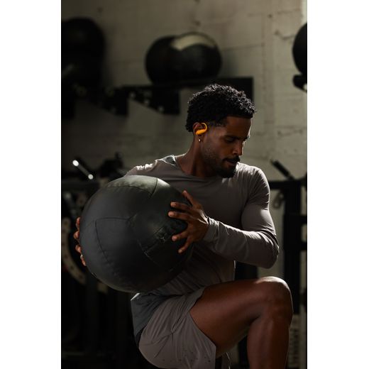 Beats Headphones - Electric Orange - Man using gym shot