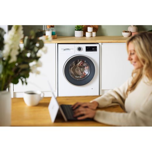 Bosch Series 6 10.5Kg / 6Kg Washer Dryer - White - women using laptop shot