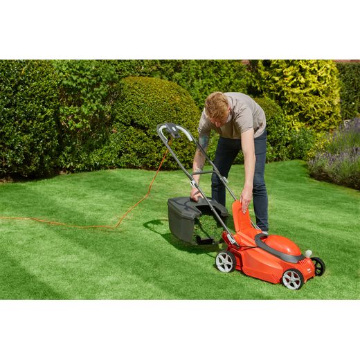 Flymo EasiStore 380R Corded Lawn Mower - Sunset Orange - person emptying grass shot