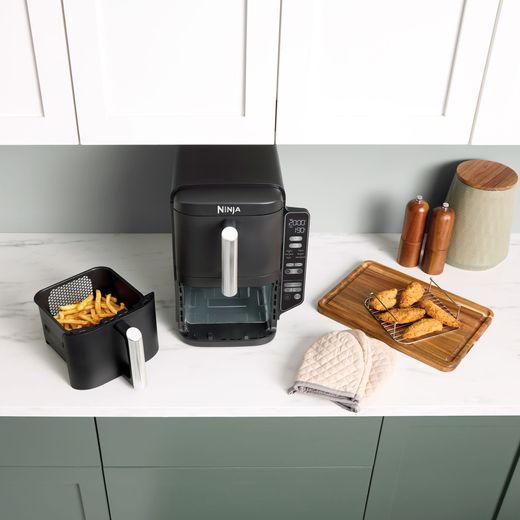 Ninja Double Stack XL SL300UK - Grey - Air fryer with chips in basket and surrounded by cooked food