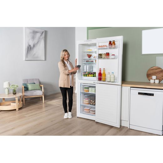 Bosch Series 2 50/50 Total No Frost Fridge Freezer - White - Women putting food in fridge shot