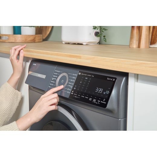 Bosch Series 6 i-Dos WGH254ARGB 10kg WiFi Connected Washing Machine with 1400 rpm - Graphite - person using control panel shot
