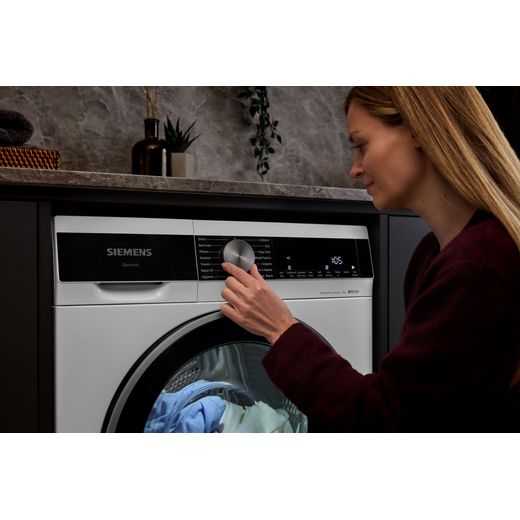 Siemens IQ-500 WQ45G203GB 9Kg Heat Pump Tumble Dryer - White - women using machine