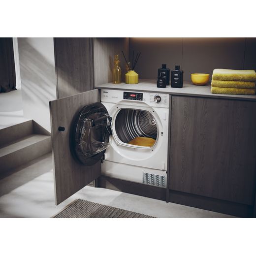 Haier 31900541 Integrated Heat Pump Tumble Dryer - White - Tumble dryer in laundry room with door open