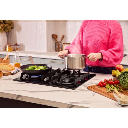 NEFF N70 T26PIP4S0 59cm Gas Hob - Black - person removing pan shot
