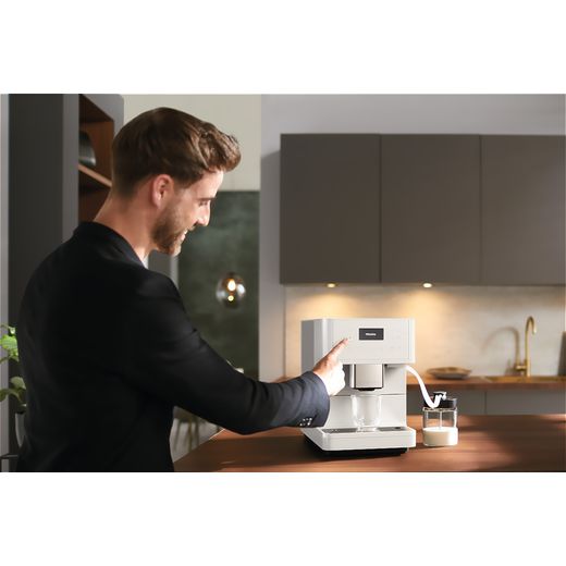Miele 11590210 Coffee Machines Lotus White - Person making coffee with machine in kitchen shot