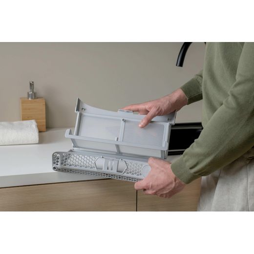 Haier X Series 7 HD100-C367GU1-UK Wifi Connected 10Kg Heat Pump Tumble Dryer - Graphite - Person cleaning lint tray shot
