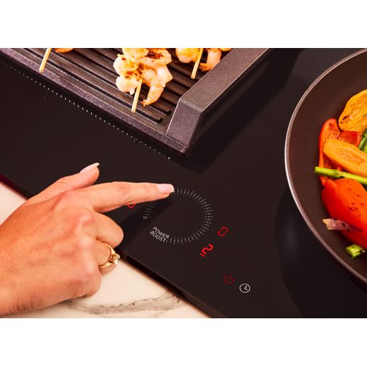 NEFF N70 T56FHS1L0 59cm Induction Hob - Black - person using dial shot