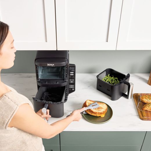 Ninja Double Stack XL SL300UK - Grey - Air fryer with cooked food next to it