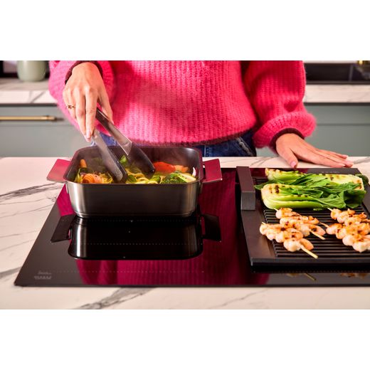 NEFF N70 T66FHX4L0 59cm Induction Hob - Black - person cooking food shot