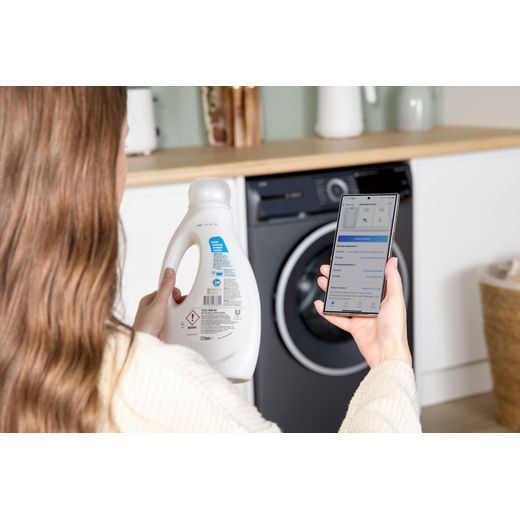 Bosch Series 6 i-Dos WGH254ARGB 10kg WiFi Connected Washing Machine with 1400 rpm - Graphite - person using phone shot