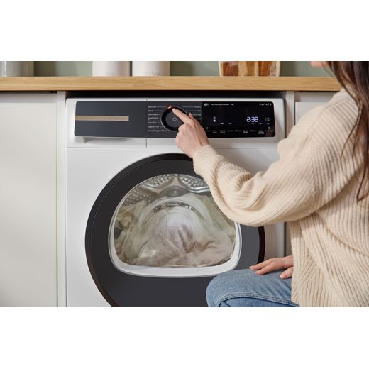 Bosch Series 6 WQH246D9GB 9Kg Heat Pump Tumble Dryer - White - person using machine shot