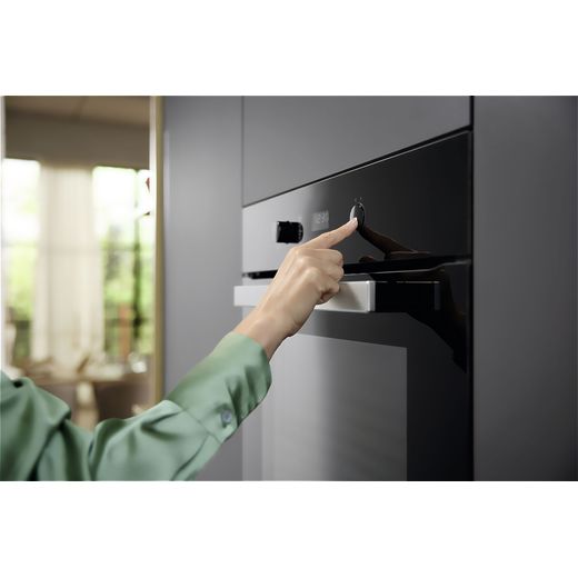 Miele Built In Electric Single Oven - Black - Person using control panel on oven shot