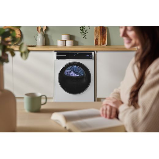 Bosch Series 8 WRB247C9GB 9Kg Heat Pump Tumble Dryer - White - person in kitchen with machine shot