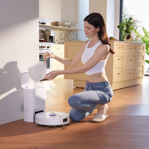Narwal Freo S Robotic Vacuum Cleaner - White - Women emptying bag shot