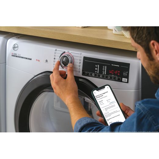 Hoover H-DRY 350 HRE H10N2TBE-80 Wifi Connected 10Kg Heat Pump Tumble Dryer - White - Person using tumble dryer shot