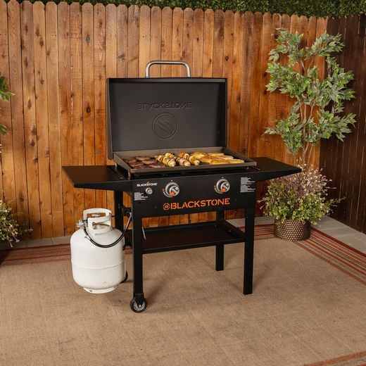 Blackstone 28in Griddle with Hood Gas Barbecue - Black - BBQ in kitchen shot
